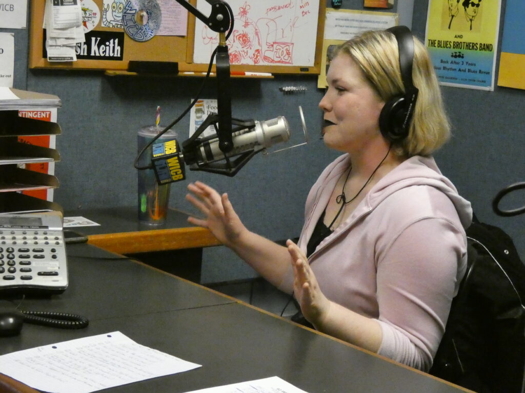 Magz1lla speaking into a microphone in the WICB homebrew radio studio